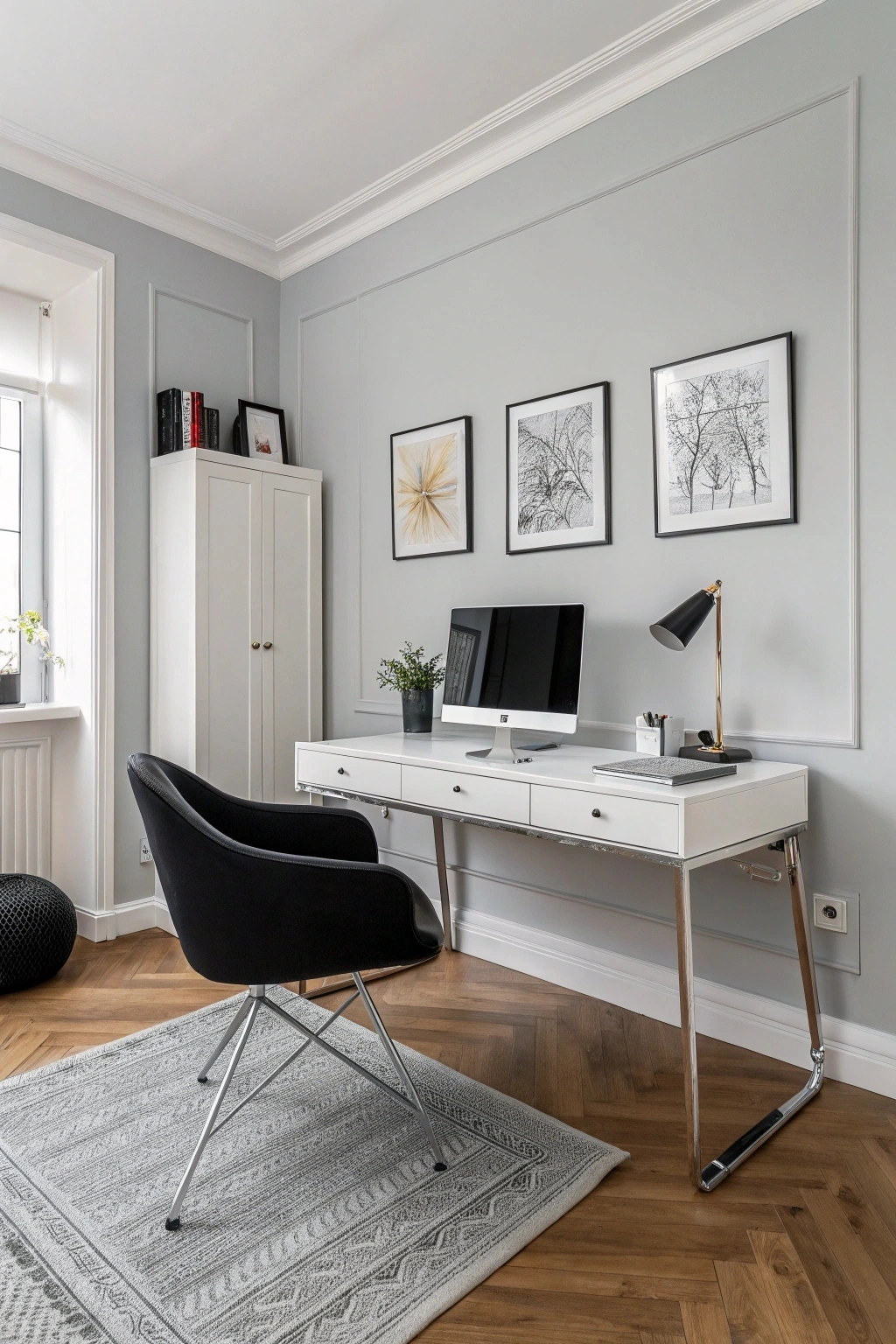 minimalist mid-century modern home office with a sleek white desk, chrome legs, black ergonomic chair, light gray walls, and a single piece of abstract art